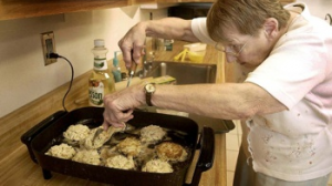 Joyce Taylor working her magic on a pan of crab cakes.