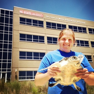 Dr. Emily Christiansen outside CMAST with a Kemp's Ridley Sea Turtle