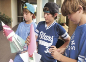 Down East Middle School students, from left, Raegann Garner, Landon Tunstall, and Corey Johnson, as part of an engineering project, build bottle rockets during The Bridge Down East summer program at Harkers Island Elementary School (Cheryl Burke photo)