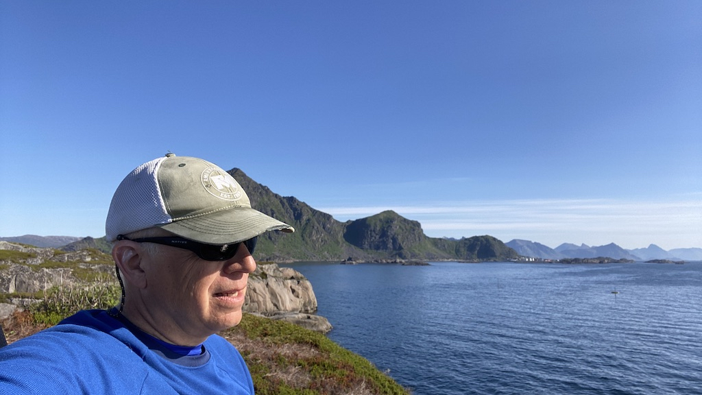 Dr. Harms on watch from Eagle's Nest looking for incoming minke whales, above the modified salmon farm ring where the hearing testing was conducted.