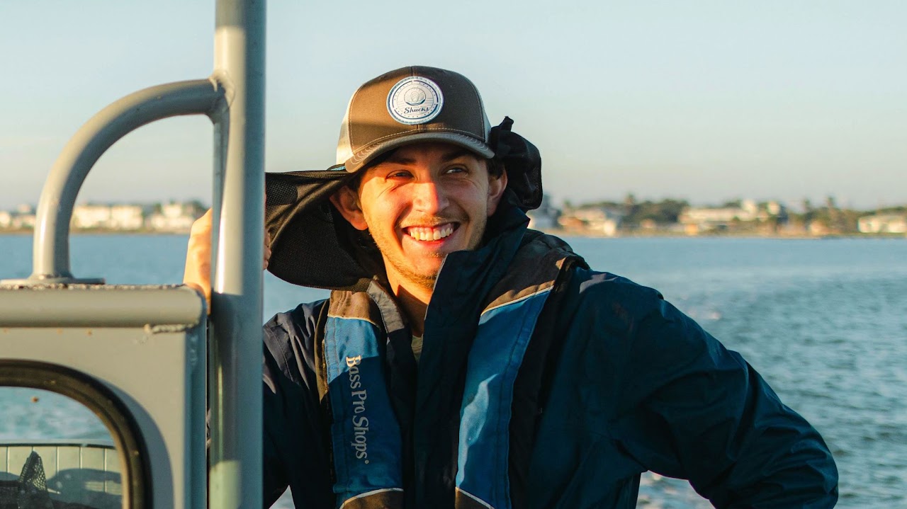 Smiling Zach Zagon on a boat